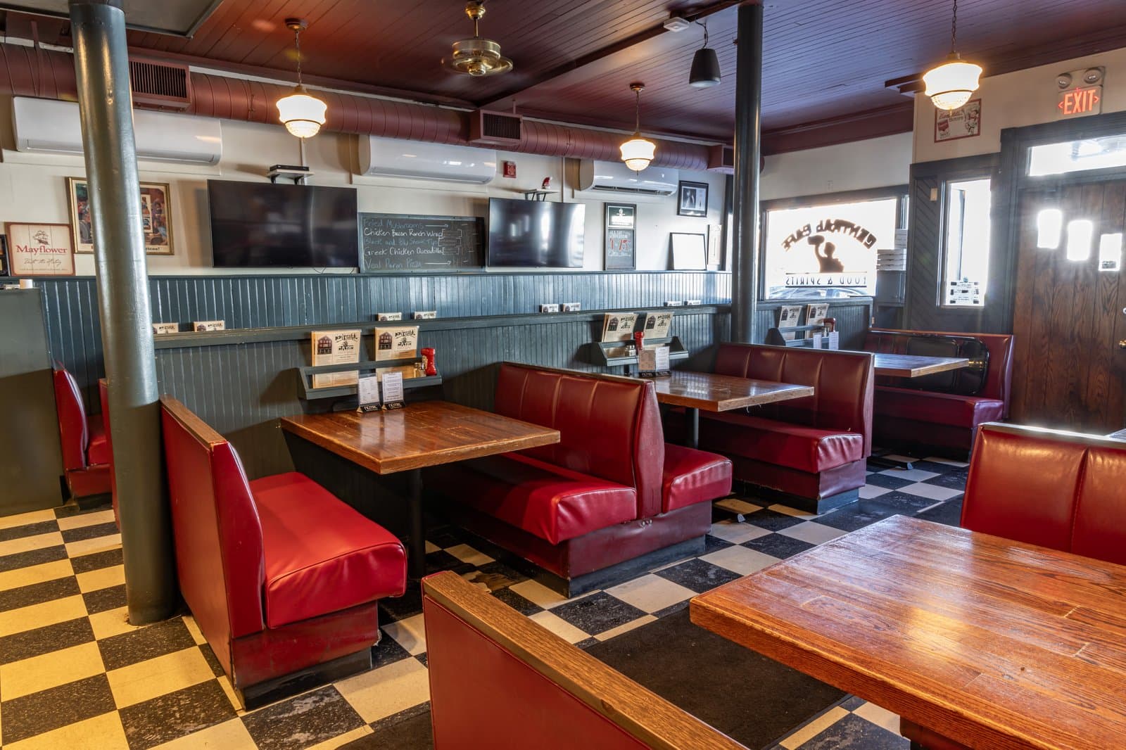 Red vinyl booths and checkered floor in the dining room