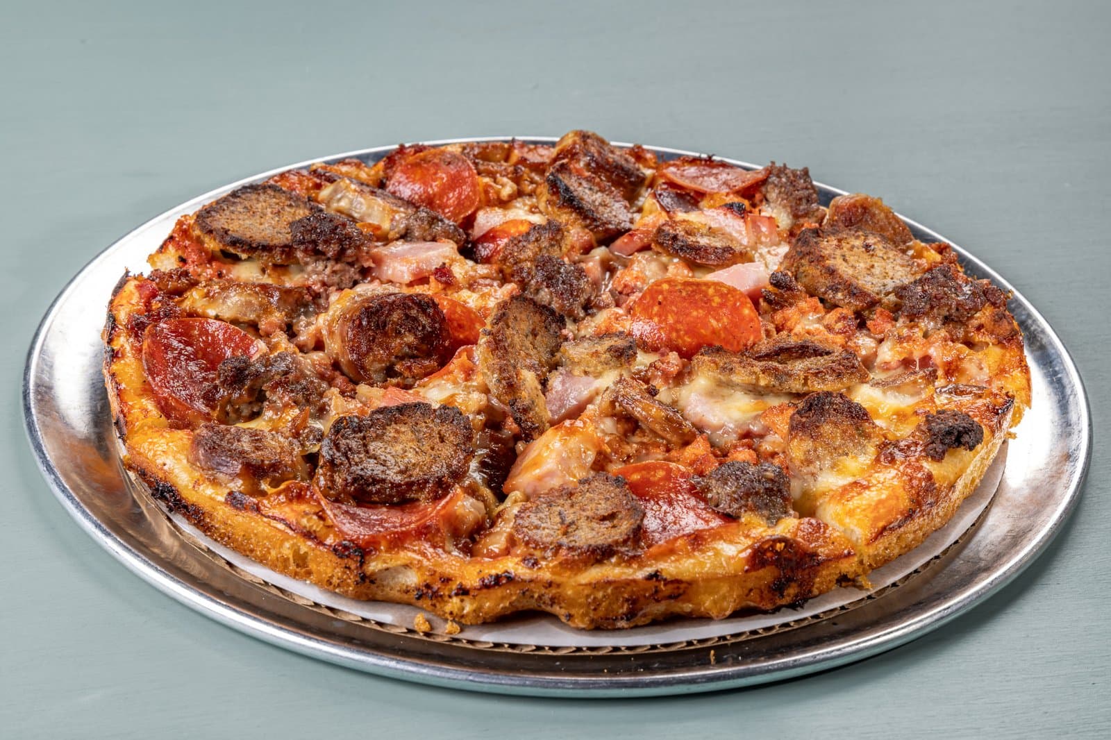 Meat lovers pizza with pepperoni, sausage, meatball, and bacon